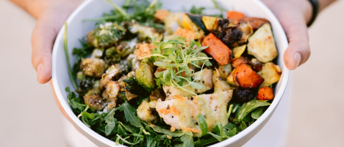 white bowl with vegetables and other food offerings